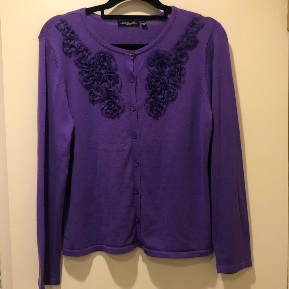 Notations purple sweater with ruffled embellishments.